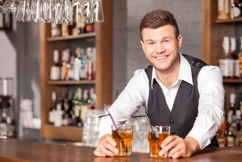 happy bartender serving drinks